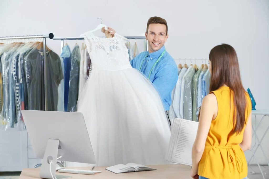 dry cleaning holding up a wedding dress